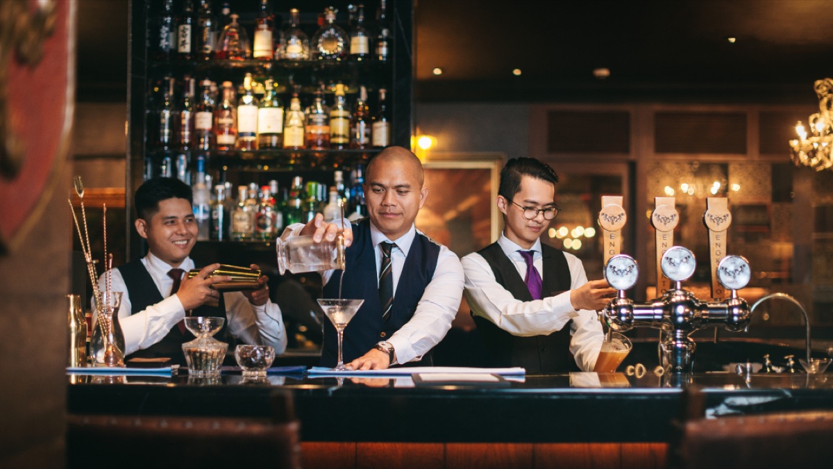 Bar staff pouring drinks