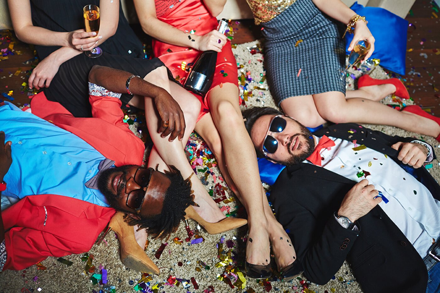 Friends lying in confetti after a party