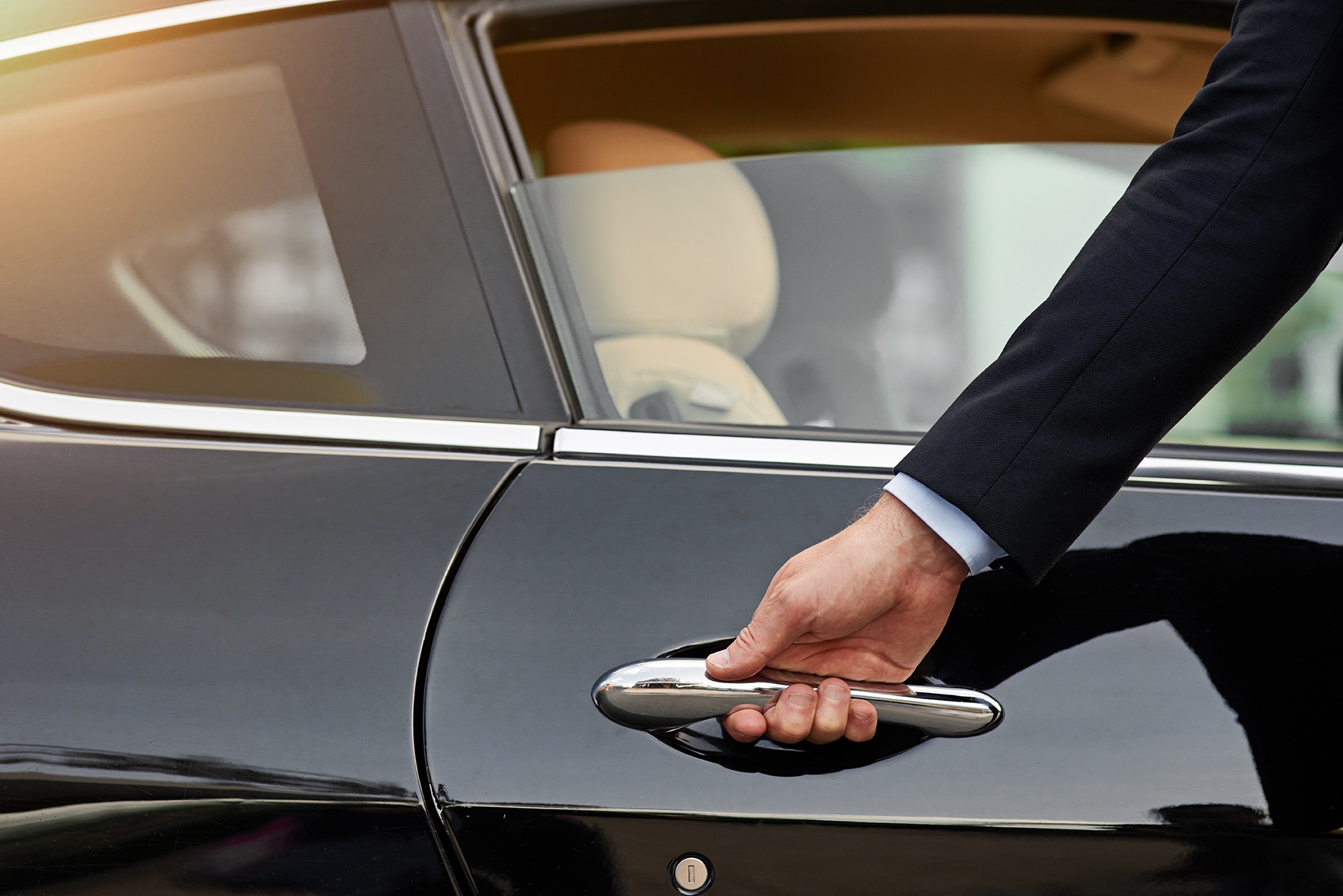 Chauffeur opening a car door